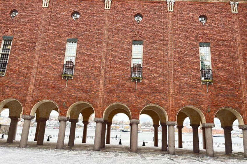 A red brick building with arched windows and columns. 4