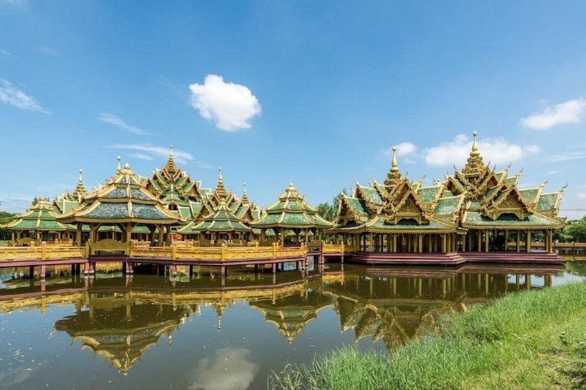 Flere traditionelle thailandske templer med gyldne tage, spejlet i vandet. 4