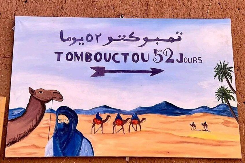 A travel poster with a camel, a woman, and camels in a desert landscape. 2