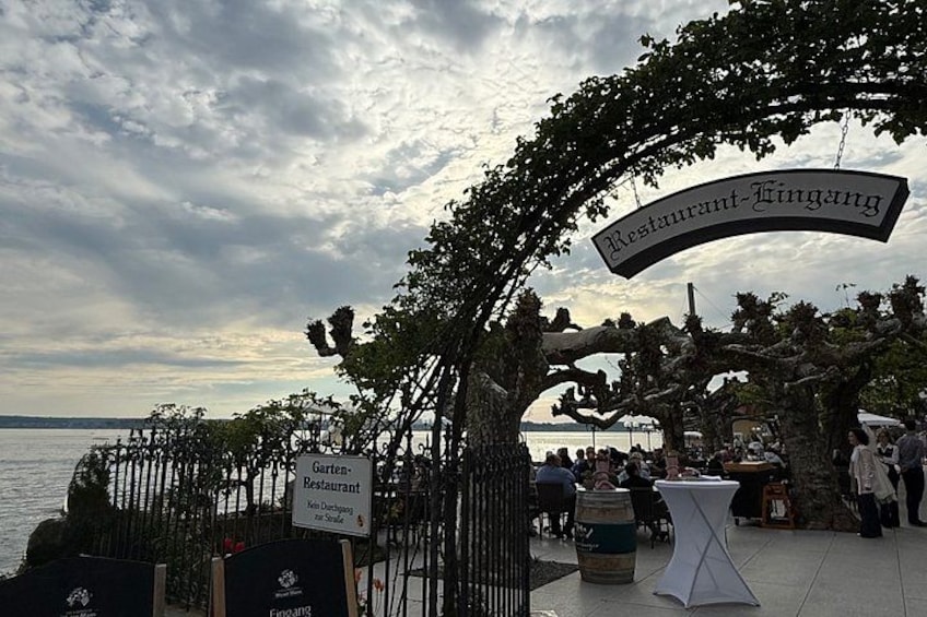 A waterfront restaurant named 'Restaurant-Fingang' with outdoor seating and a view of the water. 3
