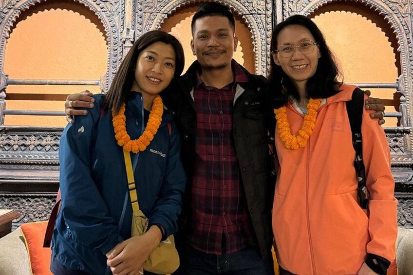 Three people standing in front of ornate architectural structures with intricate designs. 4