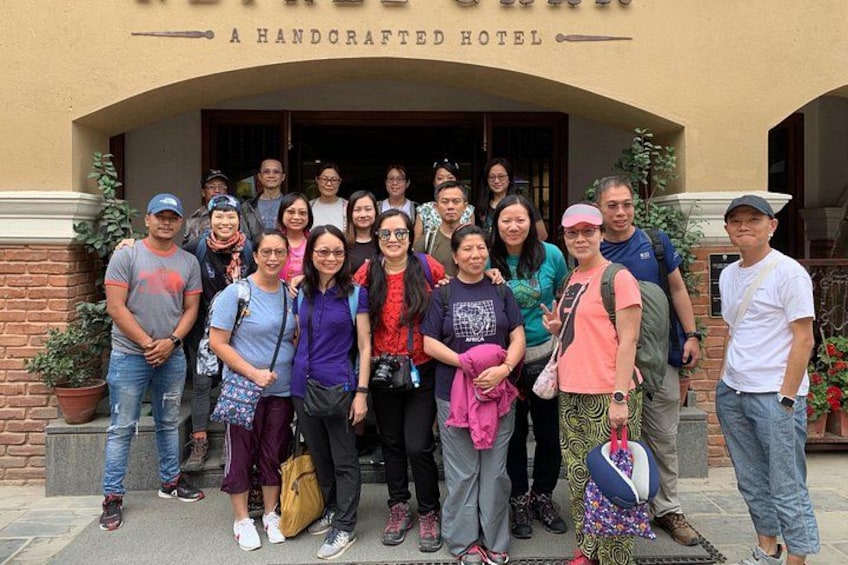 A group of people standing in front of a building labeled 'A Handcrafted Hotel.' 3