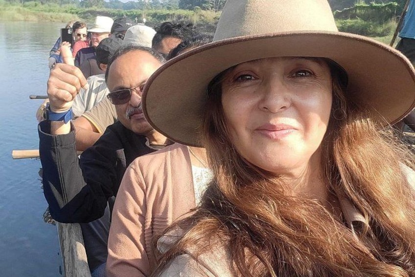 A person wearing a hat and a light-colored top. 1