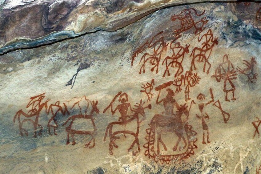 Ancient cave paintings of human figures and animals. 5