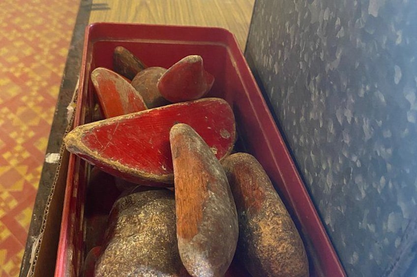A red container with several wooden objects inside. 3
