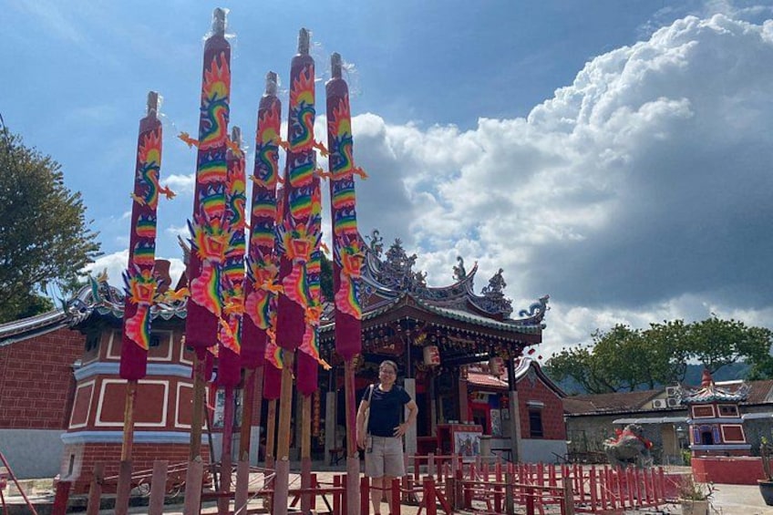 A traditional Chinese building with colorful dragon decorations and a red fence. 2