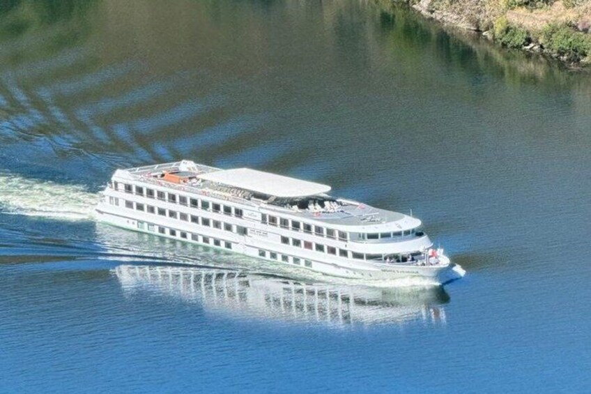 A riverboat traveling on a calm river. 3