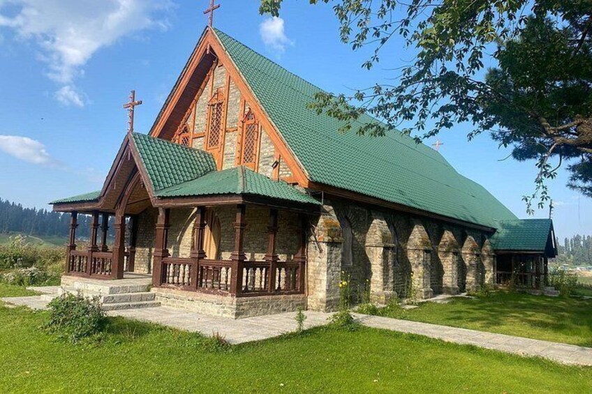 A church with a green roof and wooden architecture. 4