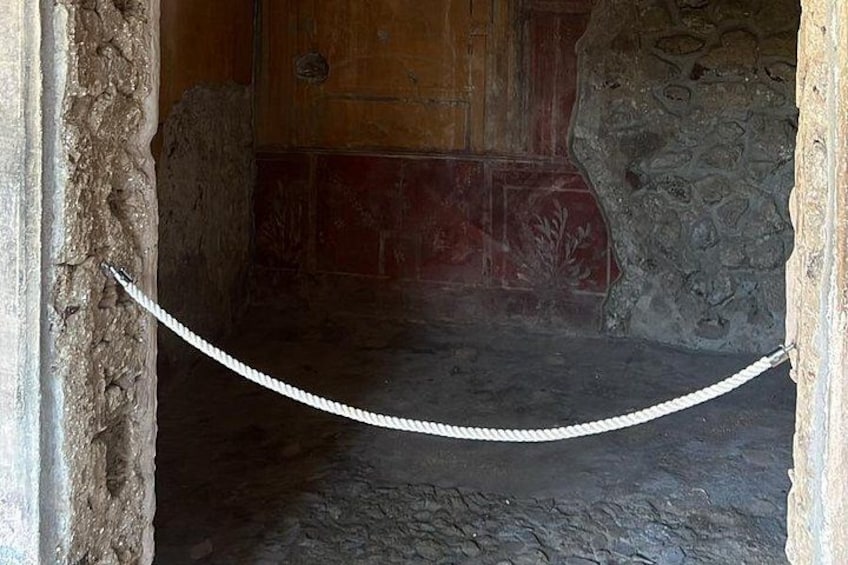 An ancient stone wall with a rope barrier. 3