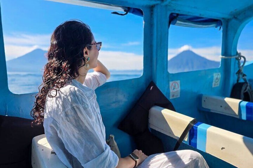 A person seated in a vehicle with a view of a mountain. 1