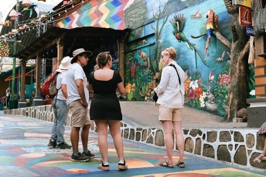 A colorful mural with birds and flowers on a building. 3
