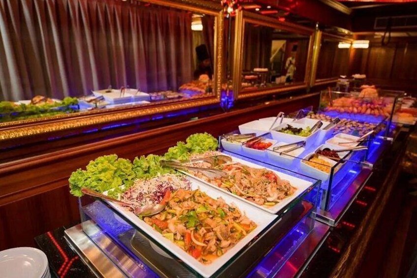 A buffet with various dishes, including salads, meats, and desserts, in a dimly lit room with wooden decor. 5