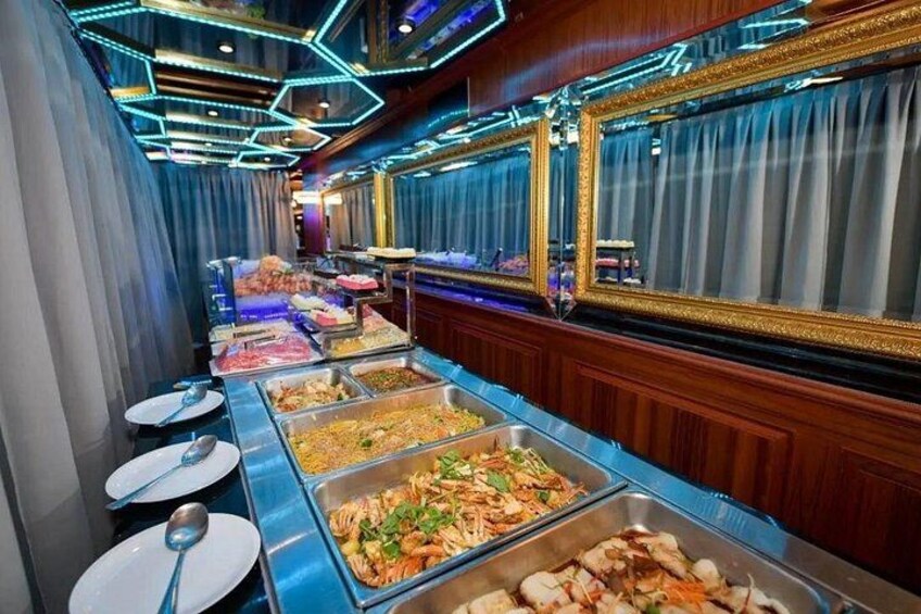 A buffet with various food options, a mirror, and a blue-lit ceiling. 3