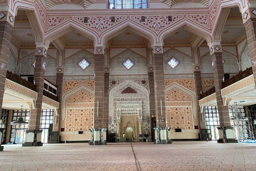 A large, ornate hall with high ceilings and intricate patterns. 4