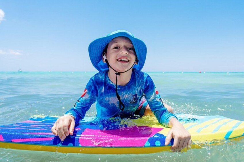A person on a colorful surfboard in the ocean. 3
