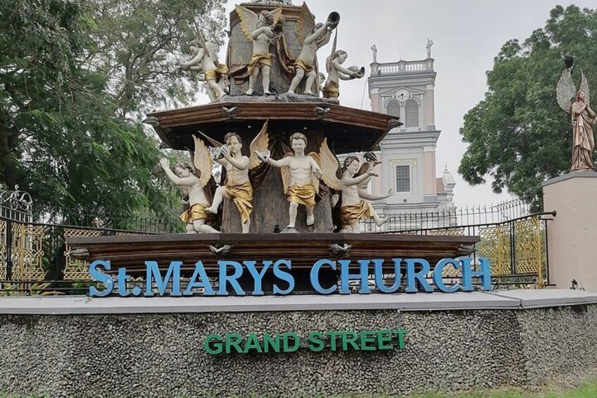 A fountain with statues of angels and the text 'St. Mary's Church' and 'Grand Street'. 4