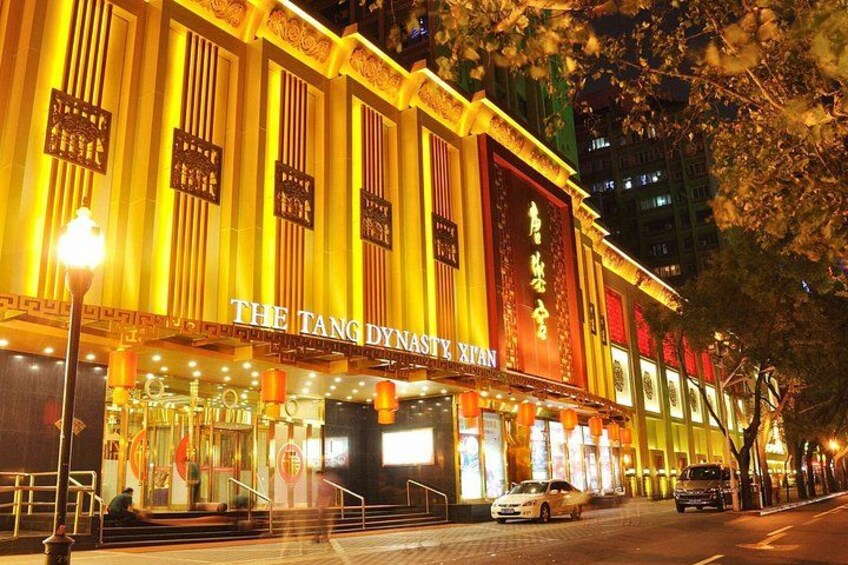 A brightly lit building with the sign 'THE TANG DYNASTY XIAN' at night. 2