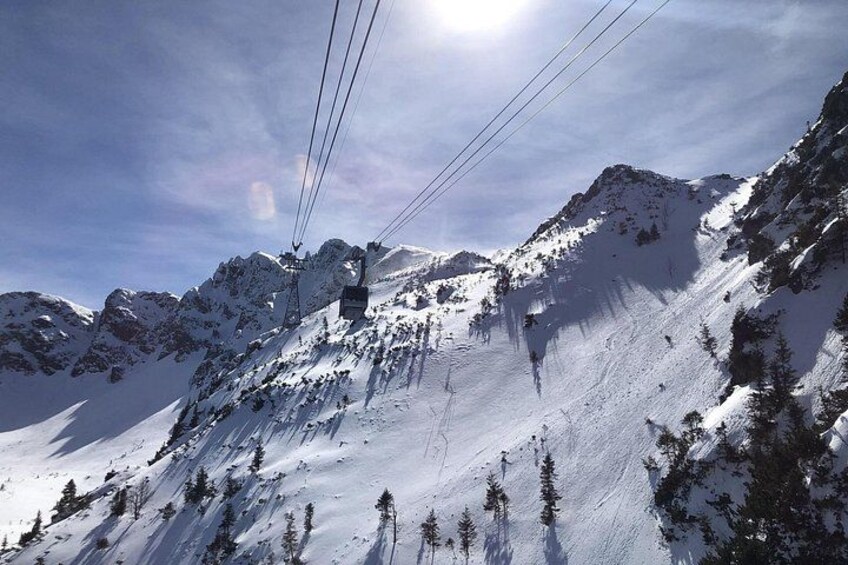 A snowy mountain landscape with ski lifts and trees. 1