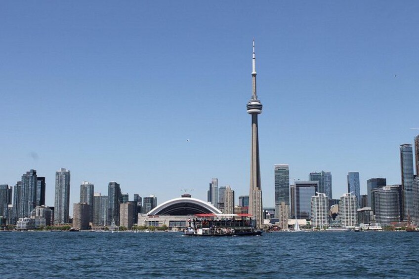 A city skyline with a prominent tower and a bridge over water. 1