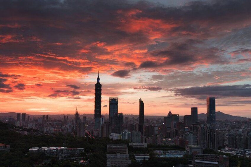 A city skyline at sunset with prominent buildings and a dramatic sky. 3