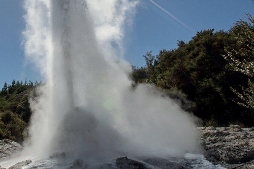 A geyser erupting with steam and water. 2