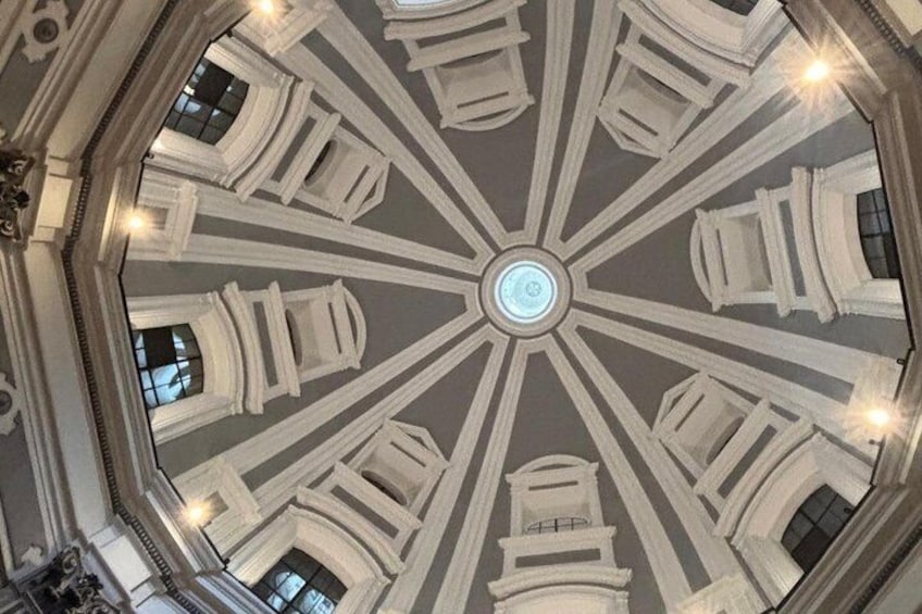 A grand, octagonal ceiling with intricate moldings and a central light fixture. 2