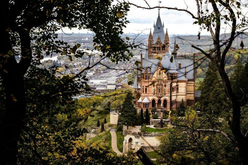 A historic building with intricate architecture, surrounded by lush greenery and a pathway leading to it. 2