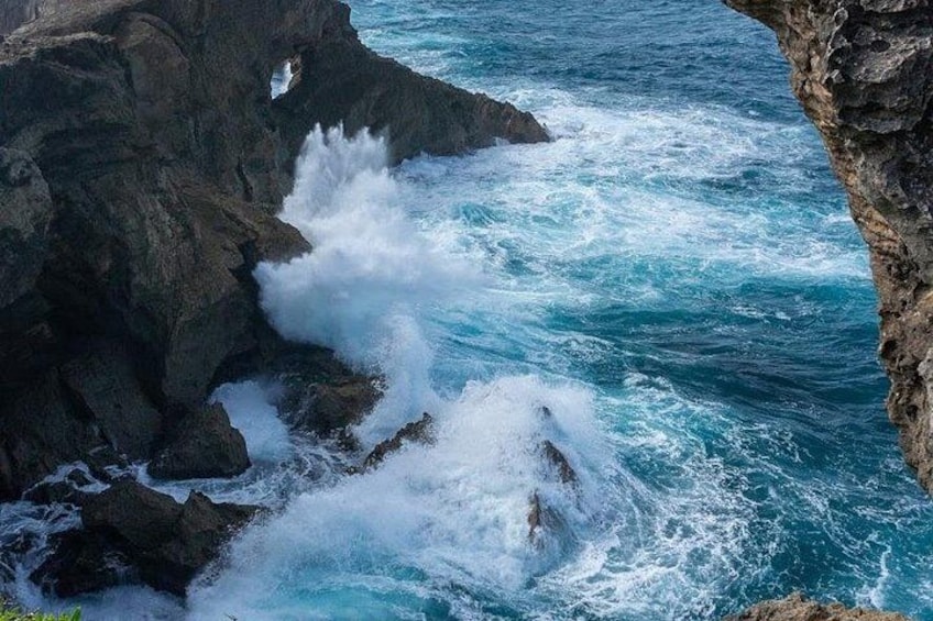 A rocky coastline with waves crashing against the rocks. 4