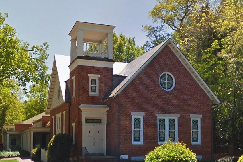 A red brick church with a bell tower and a steeple. 2