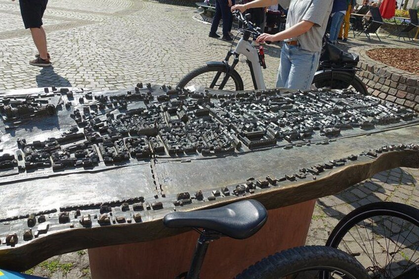 A large mechanical keyboard laid out on a wooden table outdoors. 2