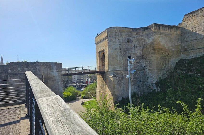 A stone bridge, a stone wall, and a metal railing. 1