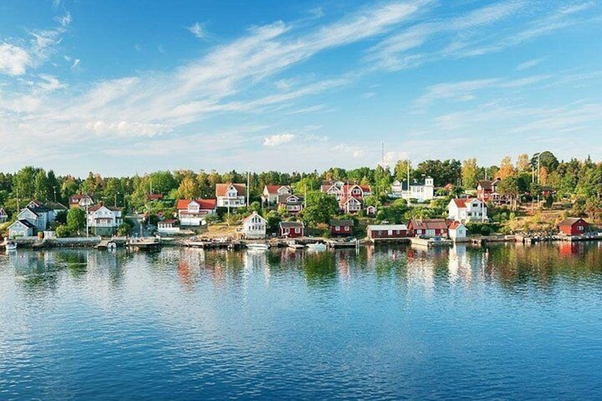 A lakeside village with houses and boats. 4