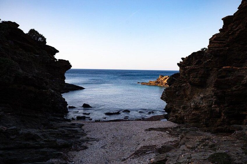 A coastal landscape with rocky cliffs and a calm sea. 2