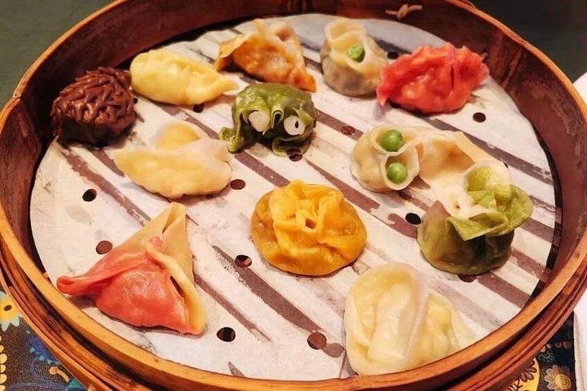 A variety of dumplings in a bamboo steamer. 3