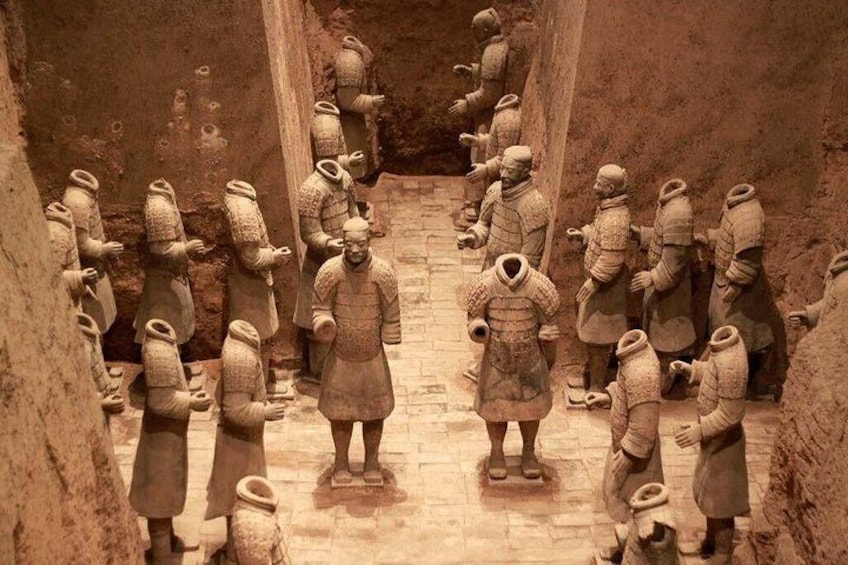 Terracotta soldiers lined up in a corridor. 5