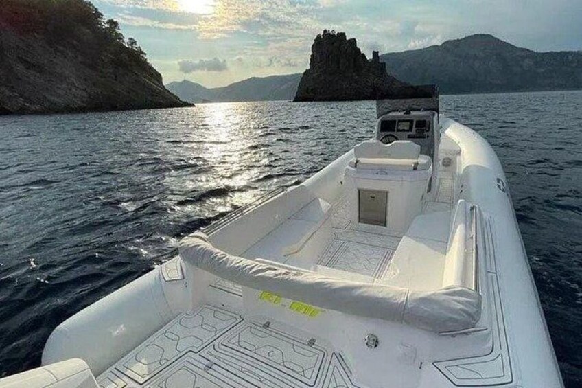 A boat on water with a rocky island in the background. 5