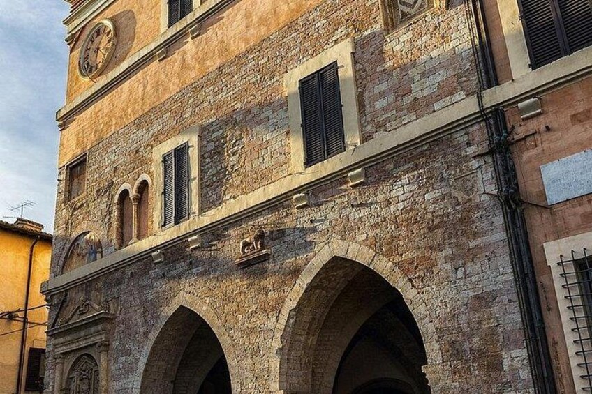 A historic building with arched windows and a clock. 3