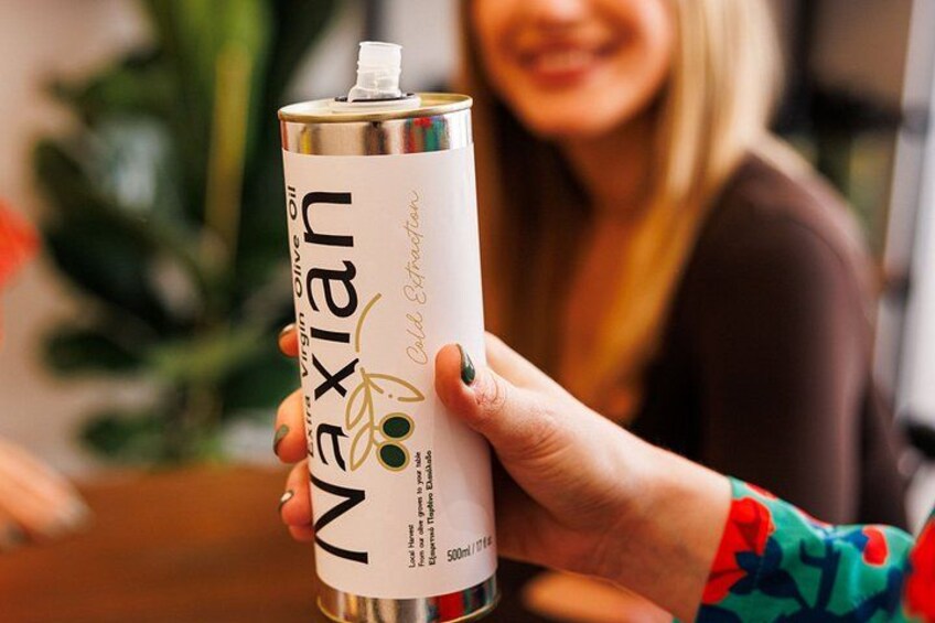 A person holding a can of Naxian wine. 3