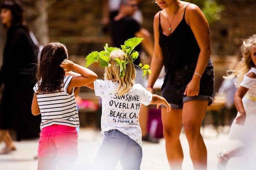 A person wearing a white t-shirt with text and a flower crown. 3
