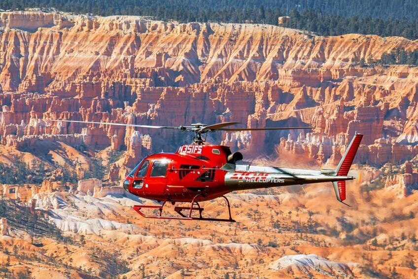 A red helicopter with 'Helicopters' and 'DHL' logos flying over a mountainous landscape. 2