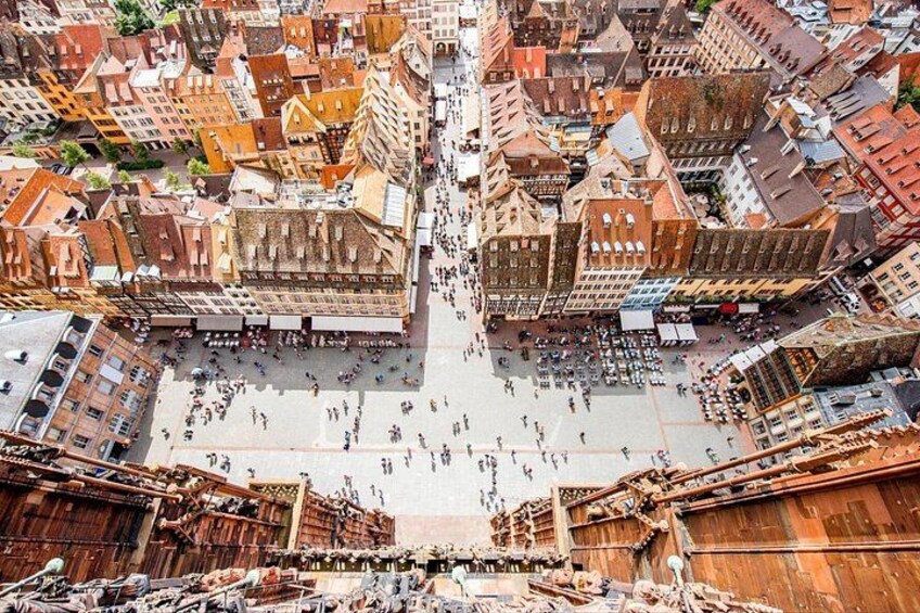 An aerial view of a historic European town square with old buildings and a large open space. 5