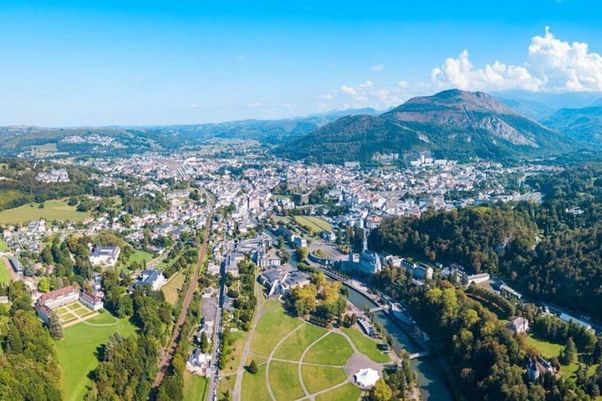 A town nestled in a valley with a mountain in the background. 2