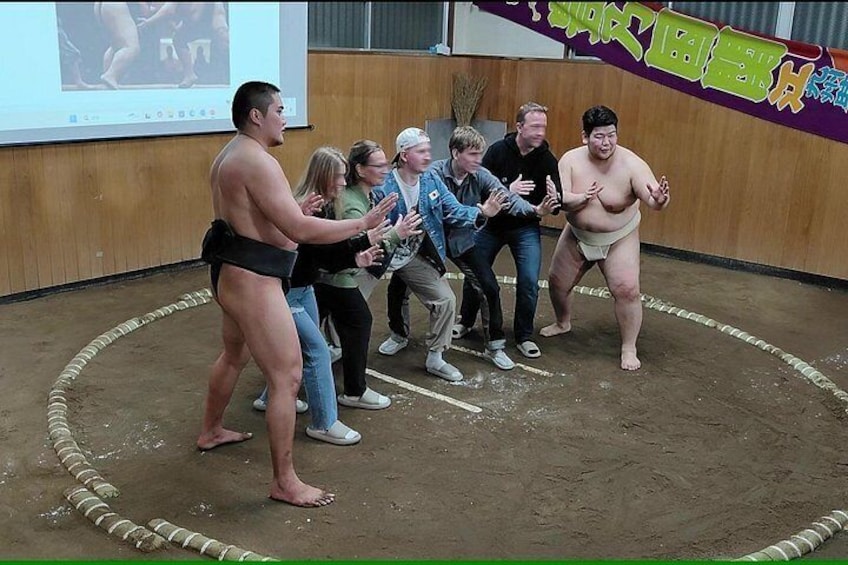 Un combate de sumo con dos luchadores y espectadores. 2