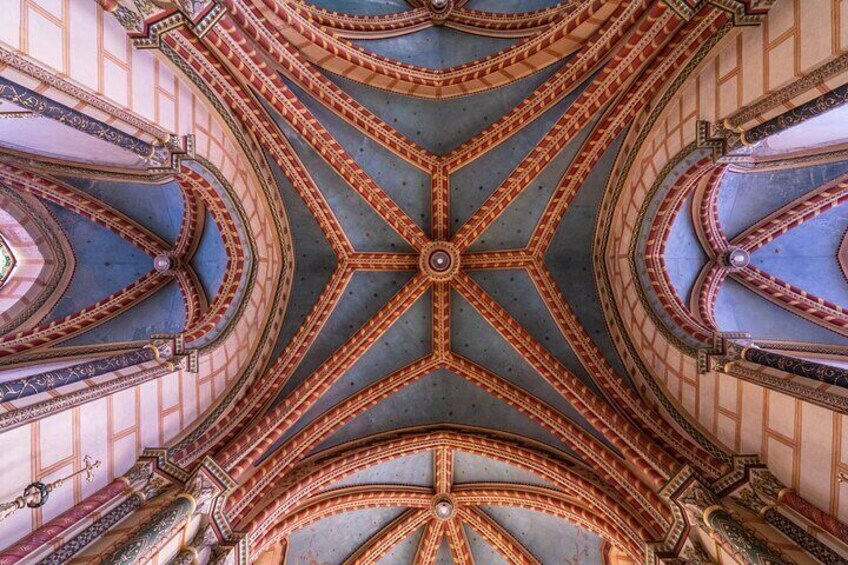 A grand, ornate ceiling with intricate patterns and a central circular design. 5