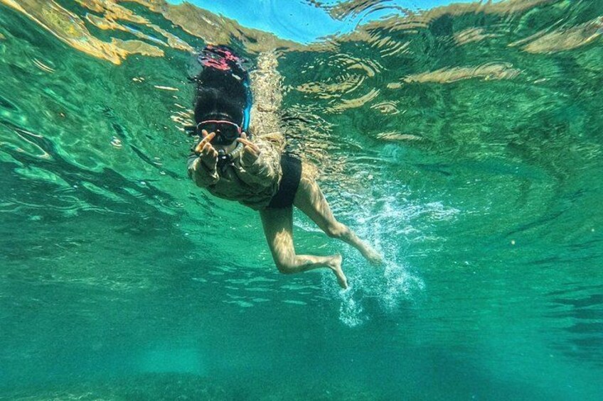 A person swimming underwater. 2