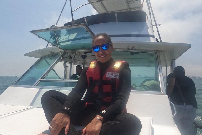 A person on a boat wearing a life jacket and sunglasses. 3