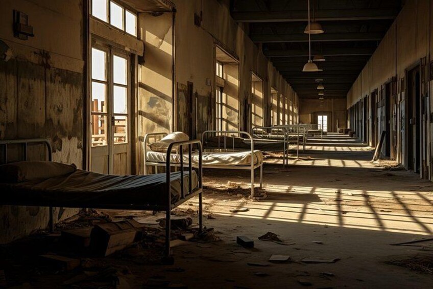 A dilapidated hospital corridor with beds, broken windows, and debris. 5