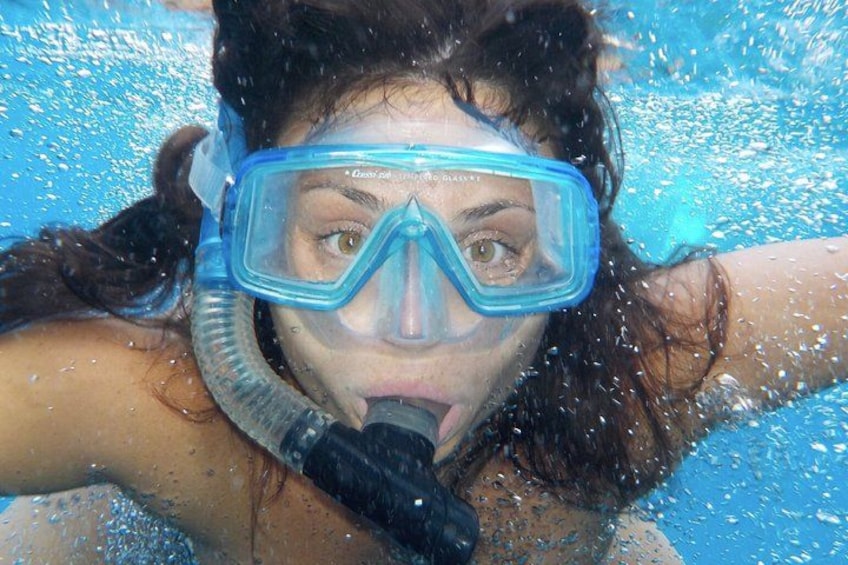 A person underwater with a snorkel and mask. 4