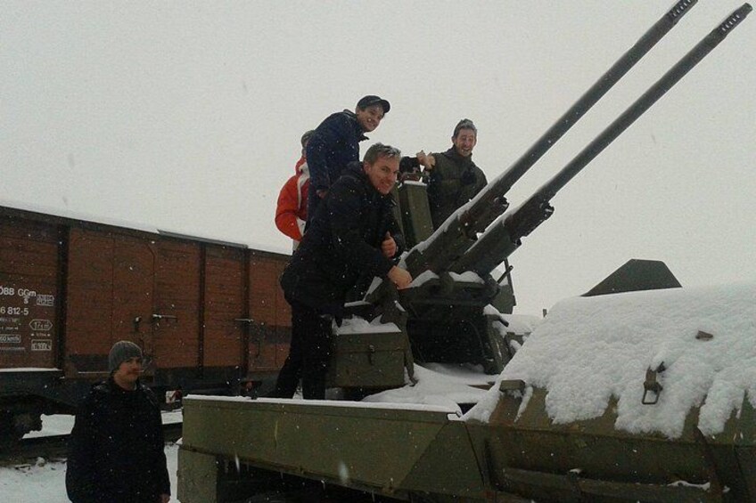 A military vehicle with a large gun in a snowy environment. 2