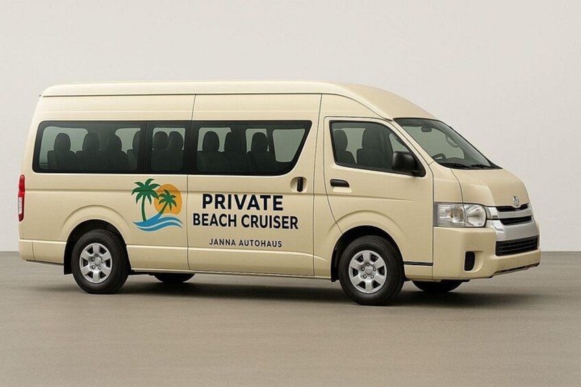 A beige van with 'PRIVATE BEACH CRUISER' and 'JANNA AUTOHAUS' branding, parked indoors. 1